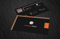 a black and orange business card on a wooden surface with q logo in the middle