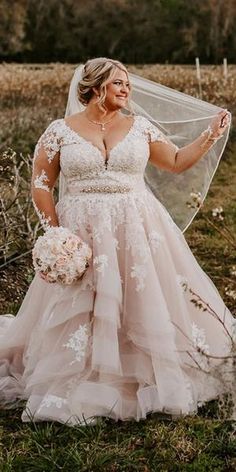 a woman in a wedding dress holding a veil