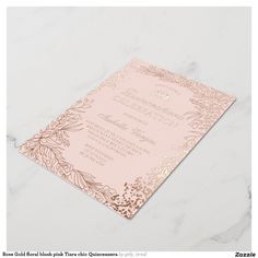 a pink and gold wedding card on a marble surface with the words,'beautiful floral design