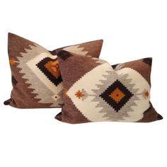 two brown and white pillows sitting next to each other