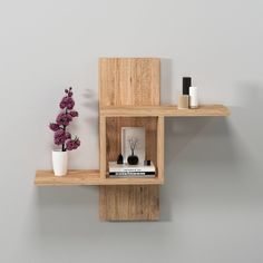 two wooden shelves with vases and books on them