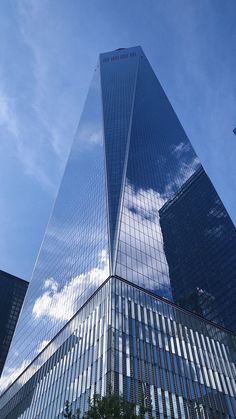 a very tall building with many windows on it's side and trees in front