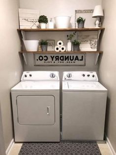 a washer and dryer in a laundry room with shelves above them that have plants on top