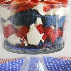 a red, white and blue trifle in a glass dish on top of a table