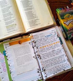 an open book sitting on top of a wooden table next to a bag of candy