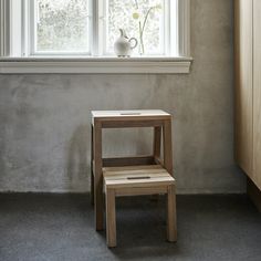 a small wooden chair sitting in front of a window