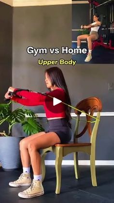 a woman is sitting on a chair with her arms stretched out and holding a gym rope