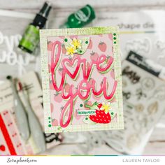 a card with the words love you written in pink and green on top of it