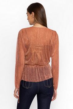 Crafted from a unique metallic blend fabric, the Duffie Wrap Blouse is equal parts delicate and feminine. Featuring a wrap-front and long sleeves, this slip-lined blouse is finished with a delicate tie at the waist. Pair with elegant black palazzo pants and heels for a polished evening look. Johnny Was Women's Duffie Wrap Blouse in Metallic Melon Pink, Size XL Chic Long Sleeve Wrap Top For Party, Spring Evening Wrap Top With Long Sleeves, Elegant Party Wrap Top With Faux Wrap, Elegant Faux Wrap Top For Party, Chic Metallic Long Sleeve Blouse, Chic Long Sleeve Metallic Blouse, Fitted Long Sleeve Shimmer Blouse, Long Sleeve Shimmer Blouse For Spring, Long Sleeve Faux Wrap Blouse For Fall