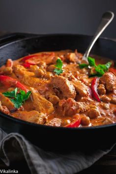 a skillet filled with meat and vegetables