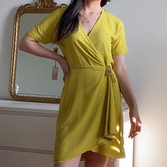 Wrap Dress In The Color Chartreuse. Brand New With Tag. Babaton's Staple Wrap Dress Is Always A Good Idea. This Is A Short, Flowy Wrap Dress With A Deep-V Neckline. The Sleek Fabric Drapes Beautifully. Fully Lined. Size: Xs. Content: 100% Polyester; Lining: 100% Polyester. Care: Machine Wash Visit My Ig For Lowest With Free Shipping (Link In Bio). Price Is Firm Here Due To Fees, Thanks For Understanding! Summer Workwear Mini Dress With Surplice Neckline, Summer Mini Dress With Surplice Neckline For Work, Yellow V-neck Midi Dress For Work, Elegant Yellow Dress For Day Out, Yellow Knee-length Daywear Dresses, Yellow Knee-length Dress For Daywear, Mustard Fitted Short Sleeve Dress, Fitted Mustard Short Sleeve Dress, Fitted Mustard Dress With Short Sleeves