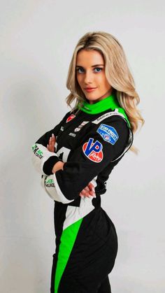 a woman in a racing suit is posing for a photo with her hands on her hips