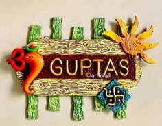 a wooden sign that says gupas with an orange bird on it's head