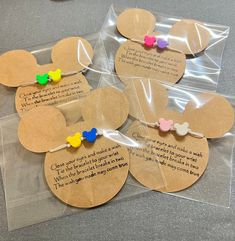 four mickey mouse ear tags with some writing on them