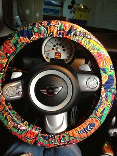 the steering wheel cover is decorated with colorful flowers