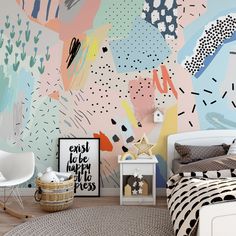 a bedroom with colorful wallpaper and white furniture