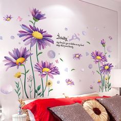 a bedroom with flowers painted on the wall