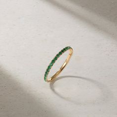 Loved for its barely there, stackable design and versatility, our Thread Ring is the most perfect choice for the modern woman. Sparkling emeralds are hand set in elegantly sculpted prongs that extend three quarters around the finger. For the minimalist, we love it as an everyday essential that can be worn on its own for an elegant and understated appearance. For those who fancy a more elaborate look, stack together multiples for a more significant statement. It can also serve as a beautiful comp Elegant Green Stackable Eternity Band, Green Emerald Stackable Rings With Prong Setting, Green Half Eternity Stackable Rings Fine Jewelry, Fine Jewelry Green Stackable Rings With Prong Setting, Green Emerald Round Cut Eternity Band, Green Stackable Eternity Band For Formal Occasions, Elegant Green Stackable Rings With Half Eternity, Green Stackable Rings With Prong Setting, Elegant Green Stackable Half Eternity Rings