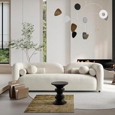 a modern living room with white furniture and large windows