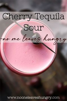 a pink drink in a glass with the words cherry tequila sour no one leaves hungry