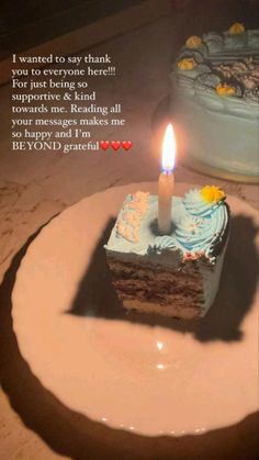 a piece of cake with a candle on it sitting in front of a birthday card