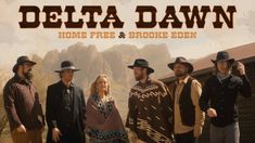 a group of men standing next to each other in front of a building with the words delta dawn on it