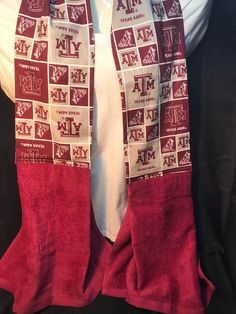 the maroon and white scarf is hanging on the back of a black jacket with red letters