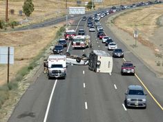 an overturned semi truck is on the highway