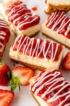 strawberry shortcakes with white icing and strawberries on a plate next to each other