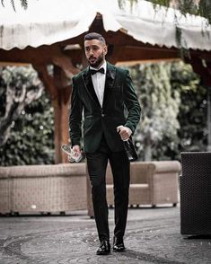 a man in a tuxedo is walking down the street