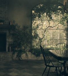 a dining room table and chairs in front of a window with ivy growing on it