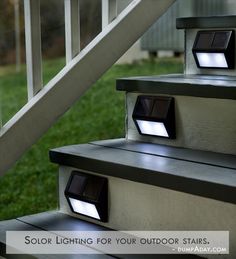 some stairs with lights on them and grass in the background