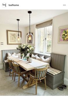 a dining room table and bench with flowers in vases on the centerpiece next to it