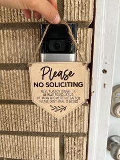 a sign hanging from the side of a door that says please no soliciting