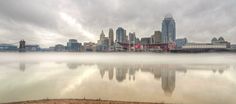 the city skyline is covered in fog as it sits on top of a body of water