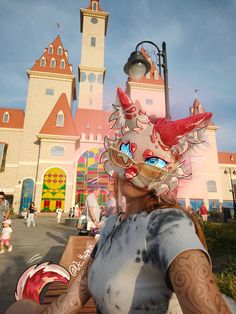 a woman wearing a mask in front of a castle