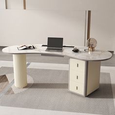 an office desk with a laptop and other items on it in a room that has carpeted flooring