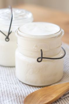 there are two jars on the table with spoons