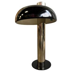 a black and gold table lamp on a white background with clippings to the bottom