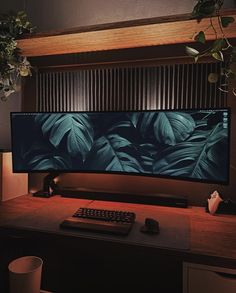 a computer monitor sitting on top of a wooden desk next to a keyboard and mouse