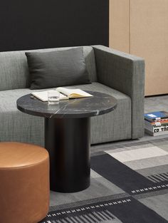 a living room with a gray couch and black table