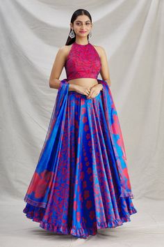 Ribbon blue lehenga in silk base with leaves red blue print and embroidered waist band. Paired with halter neck embroidered blouse and dupatta
Component: 3
Pattern: Printed
Type Of Work: Leaf Motifs
Neckline: Halter neck
Sleeve Type: Sleeveless
Fabric: Pleated Satin, Silk
Color: Blue
Other Details: 
Ruffle hem lehenga
Tassel hem dupatta
Back tassel tie-up blouse
Occasion: Destination Wedding - Aza Fashions Halter Neck Blouse Design, Sleeveless Blouse Designs, Sleeveless Blouse Saree, Halter Neck Blouses, Printed Lehenga, New Saree Blouse Designs, Halter Blouse, Blue Lehenga, Gaun Fashion