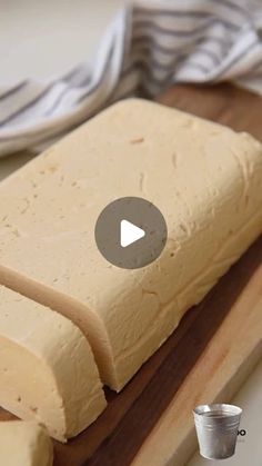 a wooden cutting board topped with sliced cheese