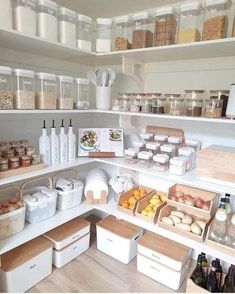 an organized pantry with lots of food and storage bins on the shelves in front of it