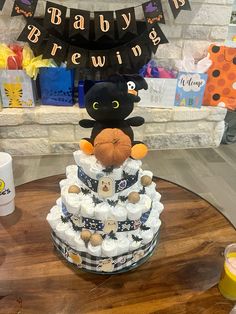 a cake made to look like a baby's first birthday with a stuffed animal on top