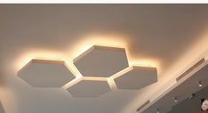 the ceiling is decorated with three hexagonal lights