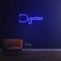 a chair and table in front of a blue wall with the word doctor on it