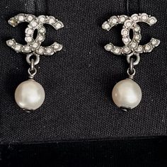 These Are Absolutely Stunning. Small Classic Cc Silver Crystal With A Faux Pearl Dangle. Can Be Worn For Daily Wear. These Are Brand New With A Small Blemish On One Of The Pearls From Storage-See Photo. There Is Also A Missing Crystal-See Photo Brand New- Have Been Stored In My Jewelry Chest Ships With Box, Ribbon, And Flower Approximate Size- This May Not Be Exact And Will Vary Depending On Placement Of Ruler- These Are Small Length: 0.5 In Height: 1 In Designer Dangle Earrings For Formal Events, Designer Dangle Earrings For Formal Occasions, Designer White Earrings For Evening, Designer White Earrings For Formal Occasions, Luxury Pearl Earrings For Evening, Luxury Aaa Quality Pearl Earrings For Formal Occasions, Luxury Aaa Quality Pearl Drop Earrings, Luxury Pearl Earrings, Chanel Stud Earrings