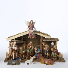 a nativity scene with figurines of people and animals in the manger