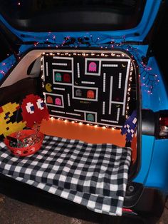 the back end of a car with an open trunk filled with items and lights on it